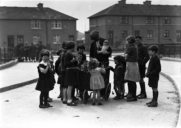 [Close-up of the rag man talking to children and holding a doll in his ...