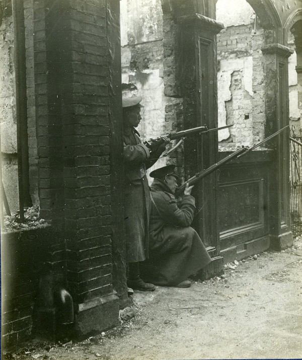 Soldiers in defensive position in the doorway and at a window of a ...