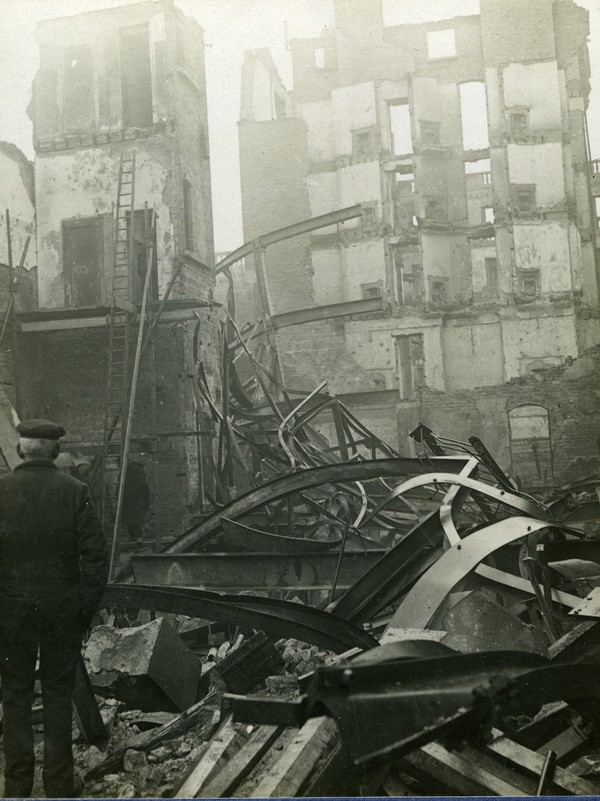 Man viewing the interior of a badly damaged building - UCD Digital Library