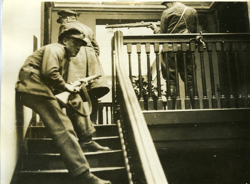 Irish Free State Army members in offensive position on the stairs of a ...